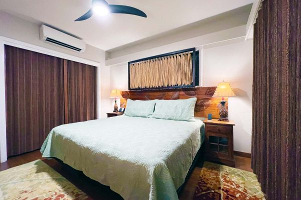 rear bedroom with air conditioning and ceiling fan is set up with king bed configuration