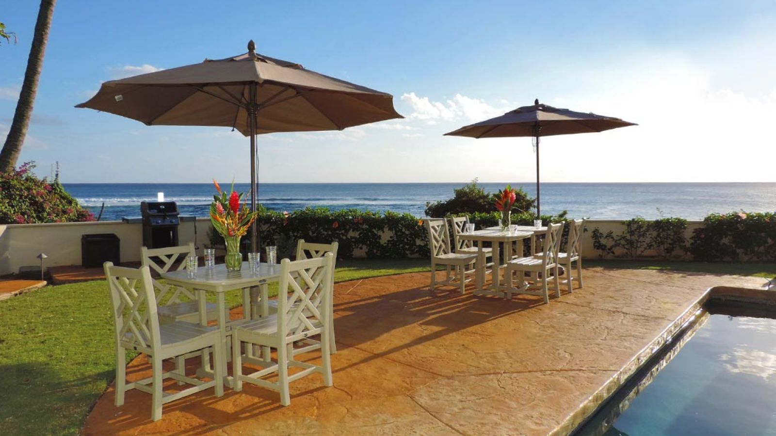 outdoor dining, barbecues and pool area at Alihi Lani Poipu oceanfront vacation rental