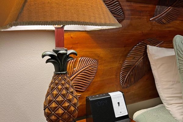 Hawaiian island-style headboard, lamp and decor in bedroom