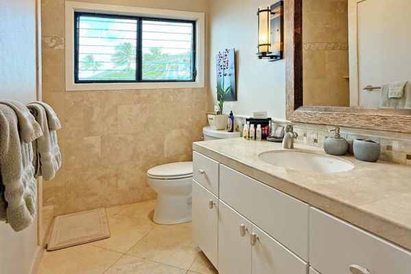 front bathroom with travertine tile