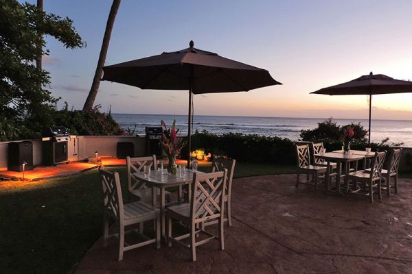 Alihi Lani 4 oceanfront Poipu vacation rental barbecue and outdoor dining area at sunset